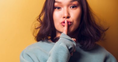 asian woman putting finger on lips